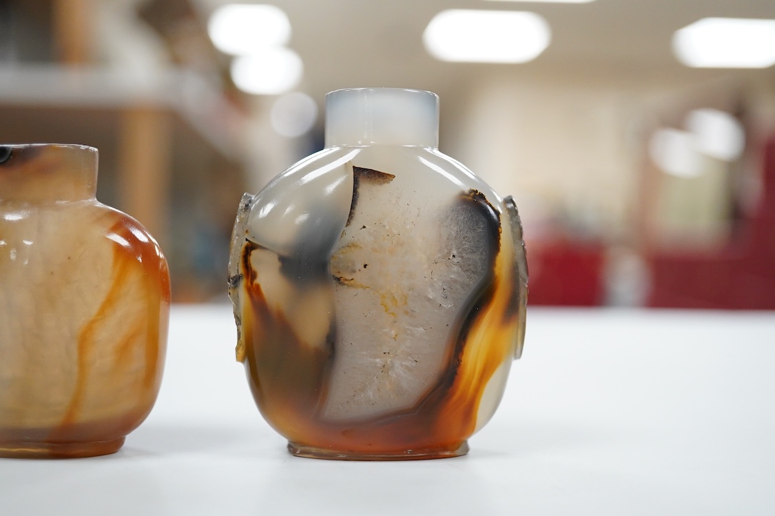 Three 19th century Chinese agate snuff bottles and a porcelain snuff bottle, largest 6cm high (4)